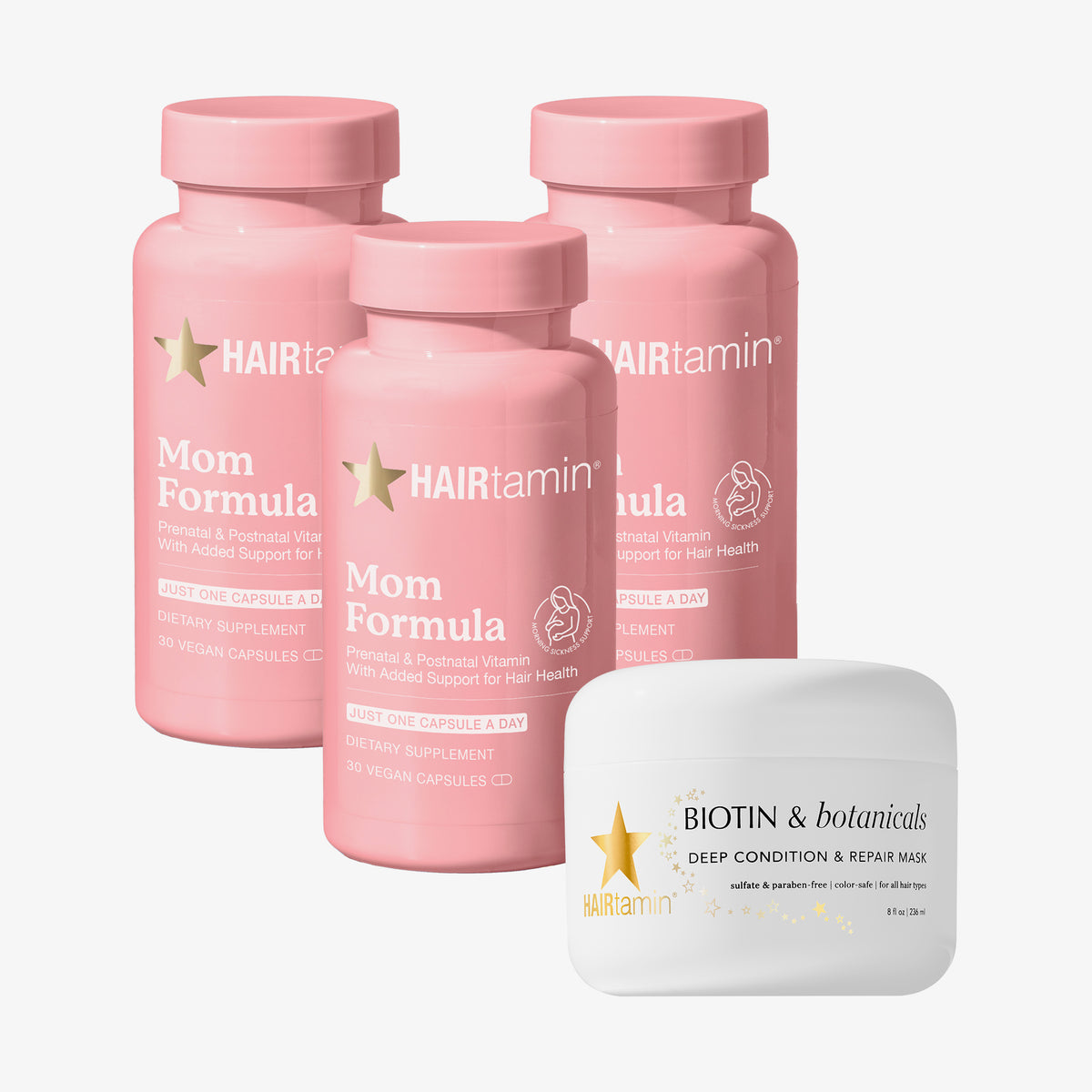 Drei rosa Flaschen des HAIRtamin
MOM Nahrungsergänzungsmittel und eine Biotin & Botanicals Deep Condition & Repair Hair Mask auf weißem Hintergrund.